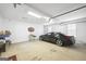 Spacious garage with vehicle and storage area with wall storage and epoxy floor at 2351 Rabbit Farm Cir, Loganville, GA 30052