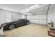 Well-lit garage featuring a parked car and plenty of room for vehicle and storage at 2351 Rabbit Farm Cir, Loganville, GA 30052