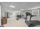 Spacious home gym featuring a treadmill, Total Gym, weight machine, and ample natural light at 2351 Rabbit Farm Cir, Loganville, GA 30052