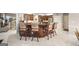 A kitchen with wood cabinets, an island with seating, and white tile flooring at 2351 Rabbit Farm Cir, Loganville, GA 30052