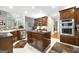Gourmet kitchen featuring dual islands, stainless steel appliances, wood cabinetry and open to living room at 2351 Rabbit Farm Cir, Loganville, GA 30052