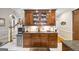 Kitchen cabinet displays tableware with undermounted lighting, beverage refrigerator and granite countertops at 2351 Rabbit Farm Cir, Loganville, GA 30052