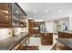The gourmet kitchen boasts sleek cabinetry, tile backsplash, stainless appliances, and spacious granite counters at 2351 Rabbit Farm Cir, Loganville, GA 30052