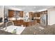 Gourmet kitchen with stainless steel appliances, double sink, ample wood cabinets and gas cooktop in the island at 2351 Rabbit Farm Cir, Loganville, GA 30052