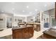 A gourmet kitchen boasts stainless steel appliances, large island, and an open layout to the dining area at 2351 Rabbit Farm Cir, Loganville, GA 30052