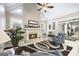 Cozy living room features a fireplace, ceiling fan, and large windows for natural light at 2351 Rabbit Farm Cir, Loganville, GA 30052