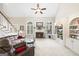 Spacious living room boasts soaring ceilings, fireplace, custom built-ins, and natural light with comfortable seating at 2351 Rabbit Farm Cir, Loganville, GA 30052