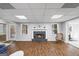 Finished living room with fireplace, hardwood floors, and neutral colored paint at 2351 Rabbit Farm Cir, Loganville, GA 30052
