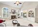Bright living room boasts fireplace, built-ins, arched windows, vaulted ceiling and neutral decor at 2351 Rabbit Farm Cir, Loganville, GA 30052