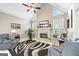 Comfortable living room with a fireplace and large windows provides ample natural lighting at 2351 Rabbit Farm Cir, Loganville, GA 30052