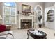 Inviting living room featuring a cozy fireplace, built-in shelving, and abundant natural light at 2351 Rabbit Farm Cir, Loganville, GA 30052