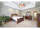 Spacious main bedroom boasting neutral walls, tray ceilings, and furnishings, creating an inviting retreat at 2351 Rabbit Farm Cir, Loganville, GA 30052