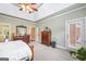 Bright main bedroom with tray ceilings, light green walls and wood furniture at 2351 Rabbit Farm Cir, Loganville, GA 30052