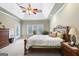 Spacious main bedroom with carpet flooring, fan, and a door leading outside at 2351 Rabbit Farm Cir, Loganville, GA 30052