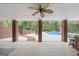 Brick columns frame this covered outdoor space offering access to the swimming pool and landscaped yard at 2351 Rabbit Farm Cir, Loganville, GA 30052