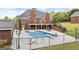 The home features a fenced backyard with a beautiful pool, covered outdoor seating, and well-manicured landscaping at 2351 Rabbit Farm Cir, Loganville, GA 30052