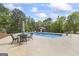 Inviting in-ground pool with a spacious patio, umbrella, lounge chairs, and a shed at 2351 Rabbit Farm Cir, Loganville, GA 30052
