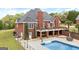 Home featuring a spacious backyard with an inviting pool, fenced perimeter, and covered outdoor seating area at 2351 Rabbit Farm Cir, Loganville, GA 30052