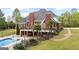 A spacious, well-maintained home with a pool, landscaped yard, and an elevated deck for outdoor enjoyment at 2351 Rabbit Farm Cir, Loganville, GA 30052