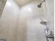 Neutral-colored tiled shower features a mounted shower head, tiled shelves and handle at 2351 Rabbit Farm Cir, Loganville, GA 30052