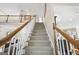 Elegant staircase leads to the upper level with wood railing and carpeted steps at 2351 Rabbit Farm Cir, Loganville, GA 30052