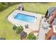 Aerial view of the pool, backyard, and patio with outdoor seating and fire pit at 2351 Rabbit Farm Cir, Loganville, GA 30052