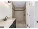 Tiled walk-in shower with a dark vanity and a sleek, modern faucet at 180 Paces Dr, Fayetteville, GA 30215