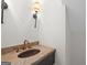 Powder room with granite countertop, custom copper sink, and modern light fixture at 180 Paces Dr, Fayetteville, GA 30215