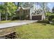 Inviting two-story brick home featuring a lush, green front yard and a convenient two-car garage at 180 Paces Dr, Fayetteville, GA 30215