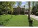 Charming brick home featuring manicured lawn, mature trees, and attached two car garage at 180 Paces Dr, Fayetteville, GA 30215