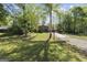 Traditional brick home with a well-manicured front lawn, long driveway, and mature trees at 180 Paces Dr, Fayetteville, GA 30215