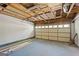 Spacious garage with exposed ceiling and automatic door, offering ample storage and parking at 180 Paces Dr, Fayetteville, GA 30215