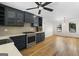 Open kitchen featuring stainless steel appliances, blue cabinets, hardwood floors and a breakfast area at 180 Paces Dr, Fayetteville, GA 30215