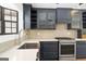 Close up of kitchen featuring stainless steel appliances and blue cabinets at 180 Paces Dr, Fayetteville, GA 30215