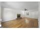Open-concept living room boasting hardwood floors, fireplace, and a modern ceiling fan at 180 Paces Dr, Fayetteville, GA 30215