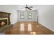 Bright living room featuring a fireplace, a ceiling fan, and hardwood flooring at 180 Paces Dr, Fayetteville, GA 30215