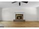 Bright living room featuring a cozy fireplace, ceiling fan, and light-colored wood flooring at 180 Paces Dr, Fayetteville, GA 30215