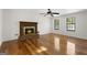 Spacious living room features a fireplace and beautiful hardwood floors at 180 Paces Dr, Fayetteville, GA 30215