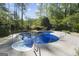 Backyard pool with ladder, complemented by concrete pool patio, perfect for outdoor entertainment and relaxation at 180 Paces Dr, Fayetteville, GA 30215