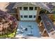 Aerial of home with deck, fire pit, and access ramp, surrounded by lush foliage at 4383 Pool Rd, Winston, GA 30187