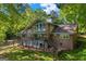 Beautiful back of brick home with large deck, lots of windows and lush greenery at 4383 Pool Rd, Winston, GA 30187
