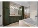 Elegant bathroom featuring dual sinks, ample storage, a soaking tub, and classic tile finishes at 4383 Pool Rd, Winston, GA 30187