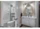 Charming bathroom with bright white cabinetry, decorative mirror, and a shower-tub combo at 4383 Pool Rd, Winston, GA 30187