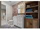 Bathroom vanity with decorative wall mirror, storage, and view into a tiled walk-in shower at 4383 Pool Rd, Winston, GA 30187
