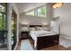 Bright bedroom features hardwood floors, a large window, and access to a balcony at 4383 Pool Rd, Winston, GA 30187