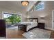 Inviting bedroom with a sliding door to deck, nice bed, stylish lamps, and hardwood floors with a modern rug at 4383 Pool Rd, Winston, GA 30187