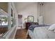 Bedroom featuring hardwood floors, a large window, and access to an ensuite bathroom at 4383 Pool Rd, Winston, GA 30187