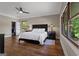 Serene bedroom offers hardwood floors, closet access, large windows with views, and stylish furniture at 4383 Pool Rd, Winston, GA 30187