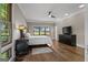 Charming bedroom features hardwood floors, large windows, and a cozy bed with dark furnishings and decorative lamps at 4383 Pool Rd, Winston, GA 30187