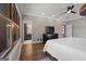 Comfortable bedroom featuring hardwood floors, a large window, and direct access to an adjoining bathroom and closet at 4383 Pool Rd, Winston, GA 30187